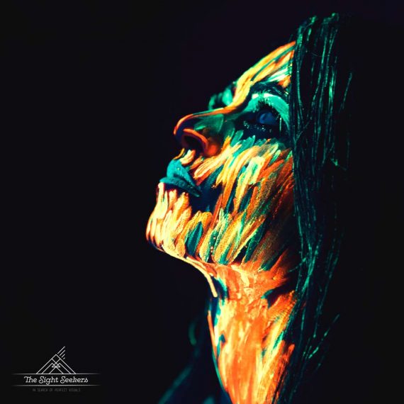 neon creative photography of girl with ultra violet face paint